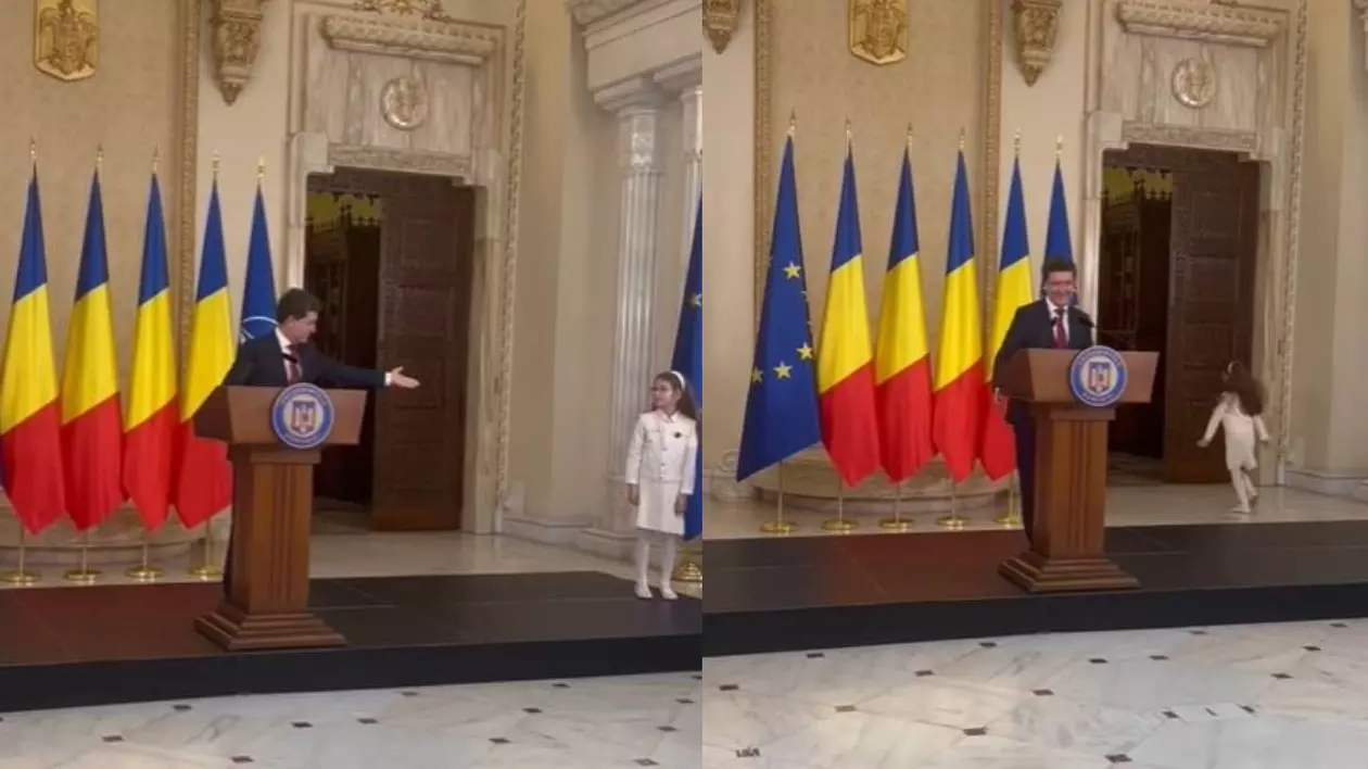 Nicușor Dan la Palatul Cotroceni, chiar înainte de discursul pe care urma să îl susțină. Președintele este îmbrăcat la costum și este întrerupt de fiica lui căreia îi face semn din mână să plece.