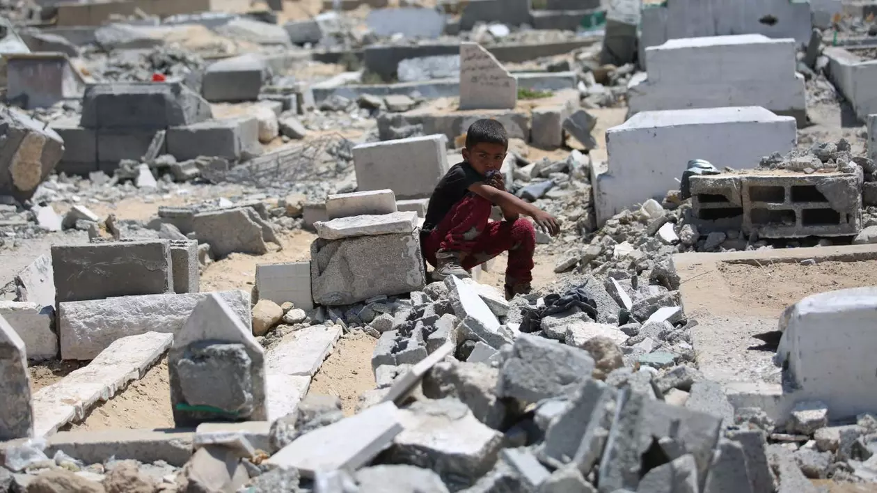 Copil stând singur printre grămezi de moloz, după un atac al armatei israeliene în Fâșia Gaza