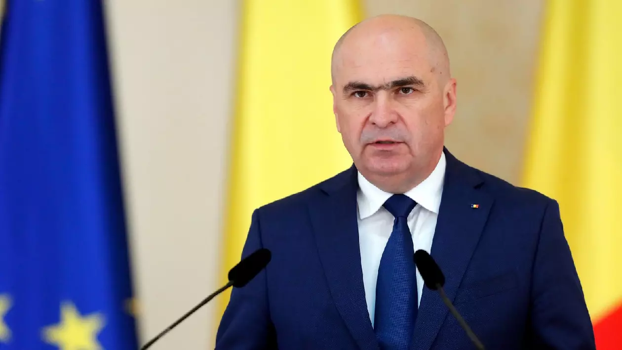 Ilie Bolojan într-un costum albastru, cămașă albă și o cravată albastră