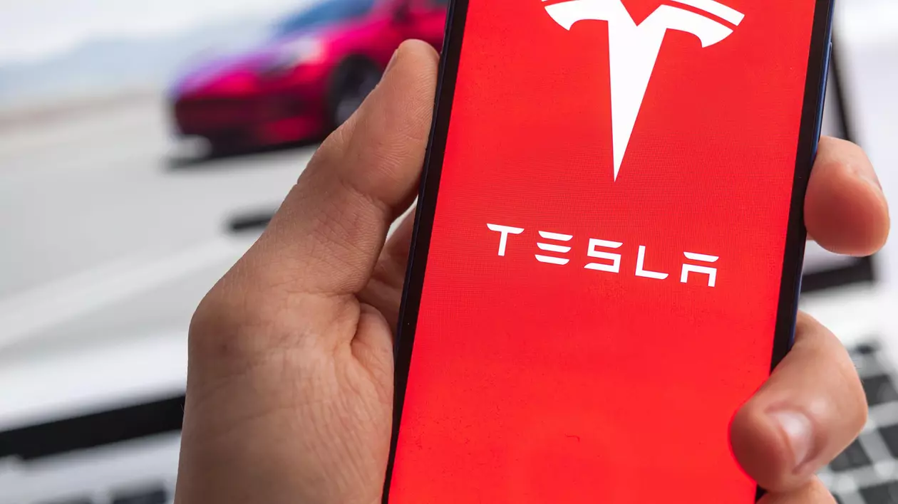 Logo-ul Tesla afișat pe ecranul unui telefon mobil