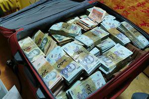 Piles of money were discovered in a man captured by the police in the capital.  What does he do?