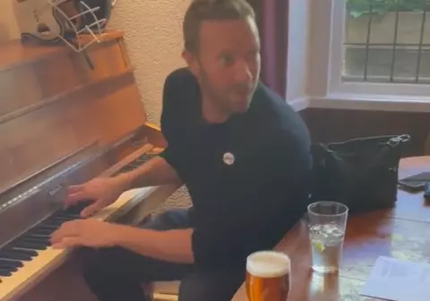 Chris Martin, solistul trupei Coldplay, cântă melodia de nuntă unui cuplu într-un bar. Imaginile au devenit virale