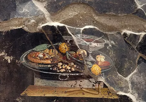 O frescă veche de 2.000 de ani, descoperită în orașul Pompei, pare să ilustreze o pizza antică