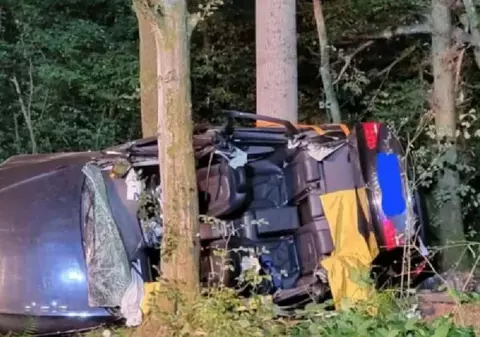 Două cupluri de români au murit într-un Audi cu volan pe dreapta, strivit între copaci, lângă o șosea din Germania