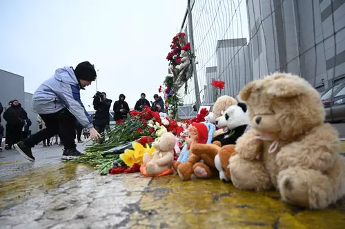 People lay flowers at Crocus City Hall after Moscow Concert Hall attack
