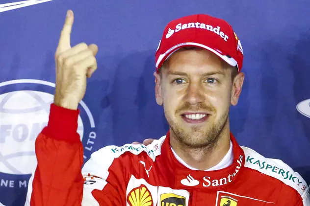Pilotul german Sebastian Vettel arată cu degetul locul 1