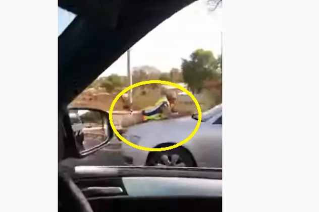 O polițistă a vrut să amendeze un șofer. Acesta a „plimbat-o” pe capotă o bună bucată de drum!