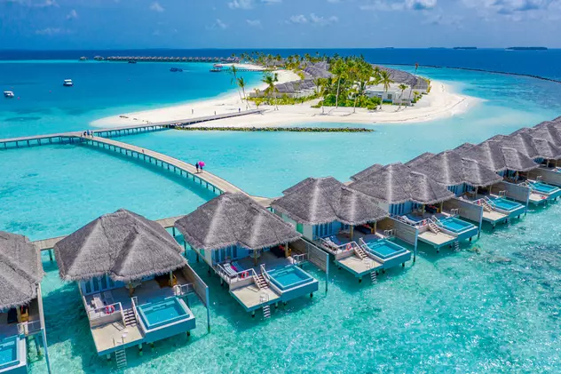 Ce poți să vizitezi în Maldive - Imagine aeriană asupra unor spaţii de cazare deasupra mării în Insulele Maldive.