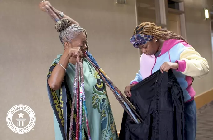 diana-armstrong-putting-on-a-coat-with-help-fron-her-grandaughtertcm25-711477