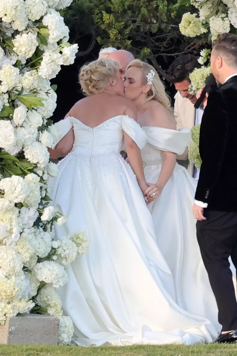 *PREMIUM-EXCLUSIVE* *MUST CALL FOR PRICING * Australian actress Rebel Wilson and her fashion designer fiancée Ramona Agruma look stunning in white wedding dresses as the couple are married in a beautiful ceremony at the Hotel Cala di Volpe in Sardinia