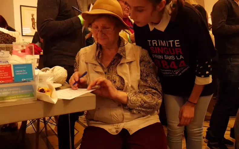 Bătrâni care joacă Bingo cu voluntari ai Asociației "Niciodată singur"