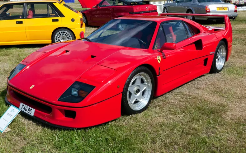 Three-quarters front view of a  Red, 1991, Ferrari F40, on display at the 2021 London Classic Car Show ,