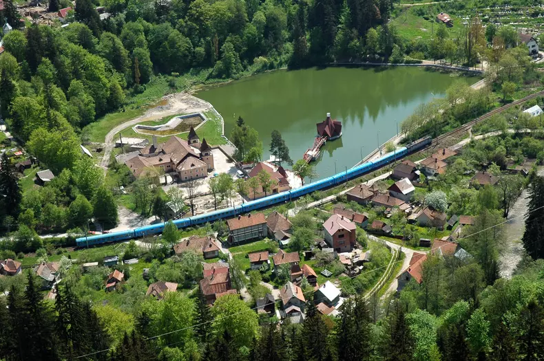 Aerial,View,Of,A,Lake,And,A,Passing,Train.,Tusnad,