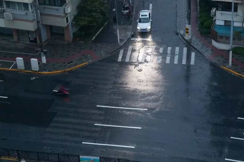 Typhoon Bebinca Approaches Shanghai SHANGHAI, CHINA - SEPTEMBER 15, 2024 - Pedestrians traveling in the rain as Typhoon