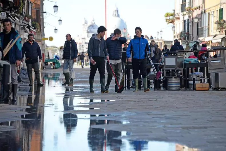 Oamenii lucrează să reparea un baraj distrus în urma inundațiilor