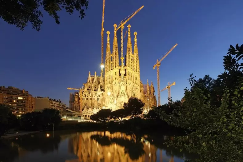 Barcelona,spain,Sagrada Famlia by Gaudi,dusk,reflexon a small lake,