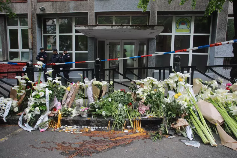 Thousands gather to pay tribute to victims of school shooting in Serbia