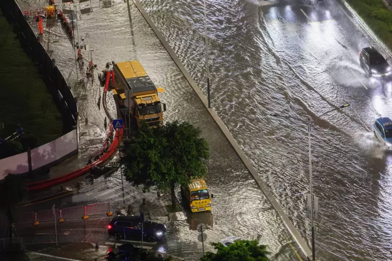 SHENZHEN, CHINA - SEPTEMBER 08: Emergency service vehicles pump water in a flooded street as Typhoon Haikui brings heavy