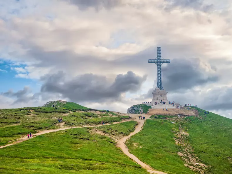 Busteni, Romania - 07.10.2021: View with the Heroes Cross on Caraiman peak, in Bucegi Mountains Romania.