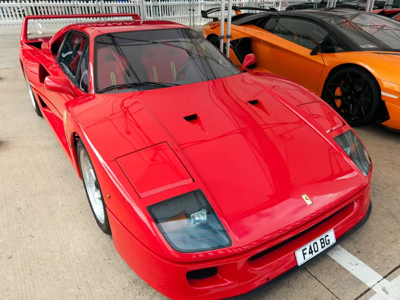 Three-quarters front view of a red, Ferrari F40, on display in the Supercar Legends Display, at the 2021 Silverstone Classic