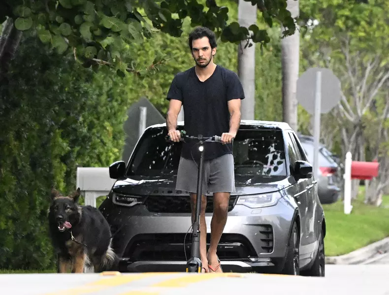 EXCLUSIVE: Gisele Bundchen's boyfriend Joaquim Valente is seen on an electric scooter with her German Shepherd dog around their Surfside neighbourhood