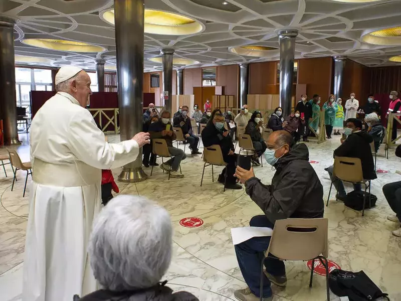 Pope Francis meets the poor awaiting vaccination