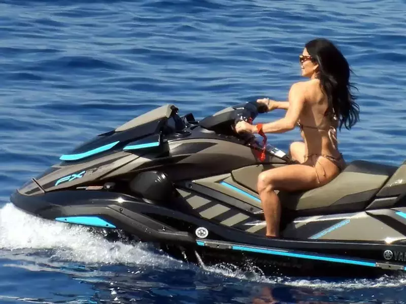 EXCLUSIVE: Lauren Sanchez rocks a tiny gold bikini as she and billionaire fiance Jeff Bezos ride jet skis on the Aegean Sea in Greece