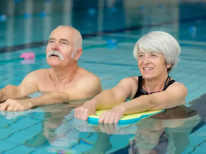 Senior,Couple,Together,In,Swimming,Pool