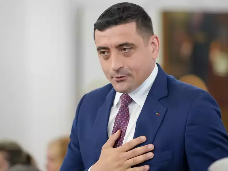 george Simion, îmbrăcat în costum bleumarin, camasa alba si cravata albastru cu rosu, tine mana pe piept