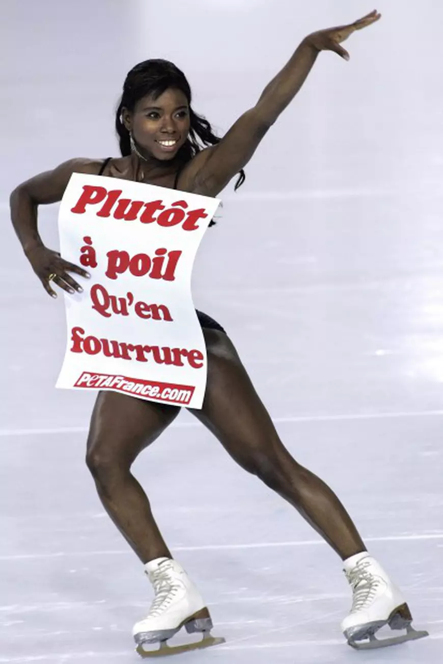 French figure skating star Surya Bonaly skates for photographers holding a placard that reads Rather naked than wearing fur, Wednesday, Jan. 31, 2007 at the Asnieres-sur-Seine skating rink, outside Paris. Bonaly supports animal rights group Peta's demand and protests against seal culls in northern Canada. (AP Photo/Jacques Brinon)