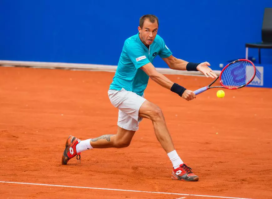 epa04724268 Lukas Rosol of the Czech Republic returns the ball to Florian Mayer of Germany during their first round match of the ATP tennis tournament in Munich, Germany, 28 April 2015. EPA/MARC MUELLER