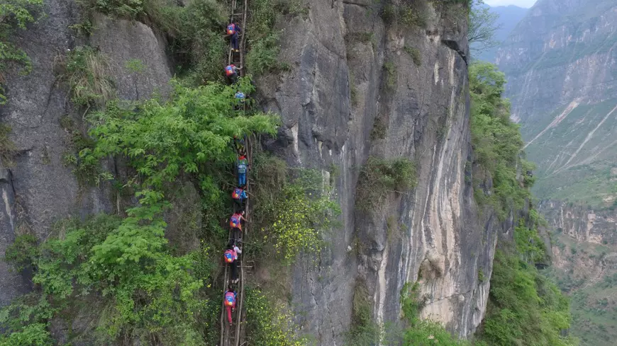 Children From Remote Chinese Village Climb Unsecured Vine Ladders On A Vertical Cliff