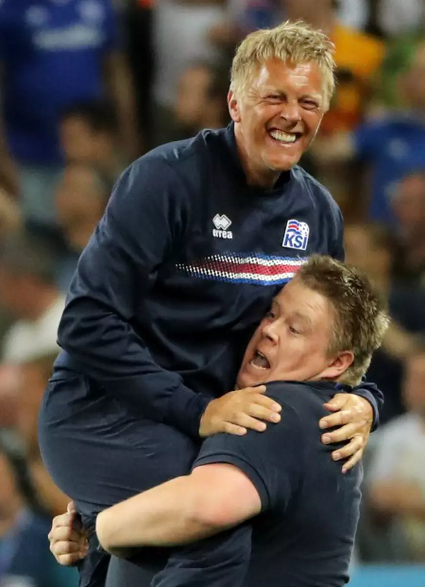 epa05395444 Iceland's coach Heimir Hallgrimsson (L) reacts at the end of the UEFA EURO 2016 round of 16 match between England and Iceland at Stade de Nice in Nice, France, 27 June 2016. Iceland won the match 2-1. (RESTRICTIONS APPLY: For editorial news reporting purposes only. Not used for commercial or marketing purposes without prior written approval of UEFA. Images must appear as still images and must not emulate match action video footage. Photographs published in online publications (whether via the Internet or otherwise) shall have an interval of at least 20 seconds between the posting.) EPA/OLIVER WEIKEN EDITORIAL USE ONLY