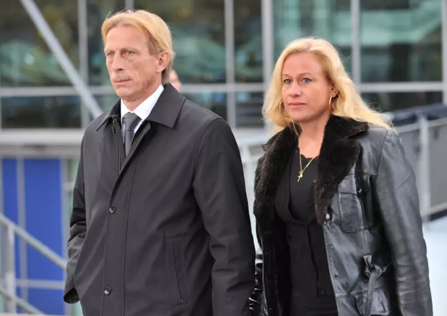 epa01934447 Christoph Daum (L), head coach at Turkish side Fehnerbahce Istanbul, and his wife Angelica Camm-Daum (R) leave the obsequies for Germany goalie Robert Enke at AWD Arena stadium in Hanover, Germany, 15 November 2009. Enke committed suicide on late 10 November 2009 near his home. EPA/PETER STEFFEN