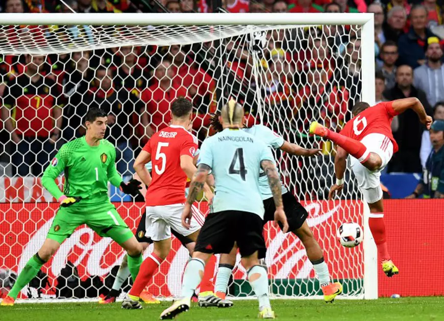 epa05402100 Ashley Williams (R) of Wales scores the equalizer during the UEFA EURO 2016 quarter final match between Wales and Belgium at Stade Pierre Mauroy in Lille Metropole, France, 01 July 2016. (RESTRICTIONS APPLY: For editorial news reporting purposes only. Not used for commercial or marketing purposes without prior written approval of UEFA. Images must appear as still images and must not emulate match action video footage. Photographs published in online publications (whether via the Internet or otherwise) shall have an interval of at least 20 seconds between the posting.) EPA/GEORGI LICOVSKI EDITORIAL USE ONLY