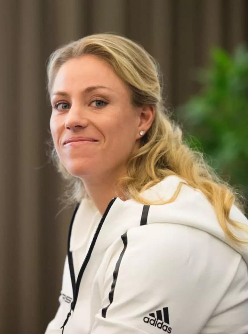 epa05537564 US Open winner of 2016 Angelique Kerber smiles during a press conference at the Hilton Airport Hotel in Munich, Germany, 13 September 2016. EPA/MATTHIAS BALK