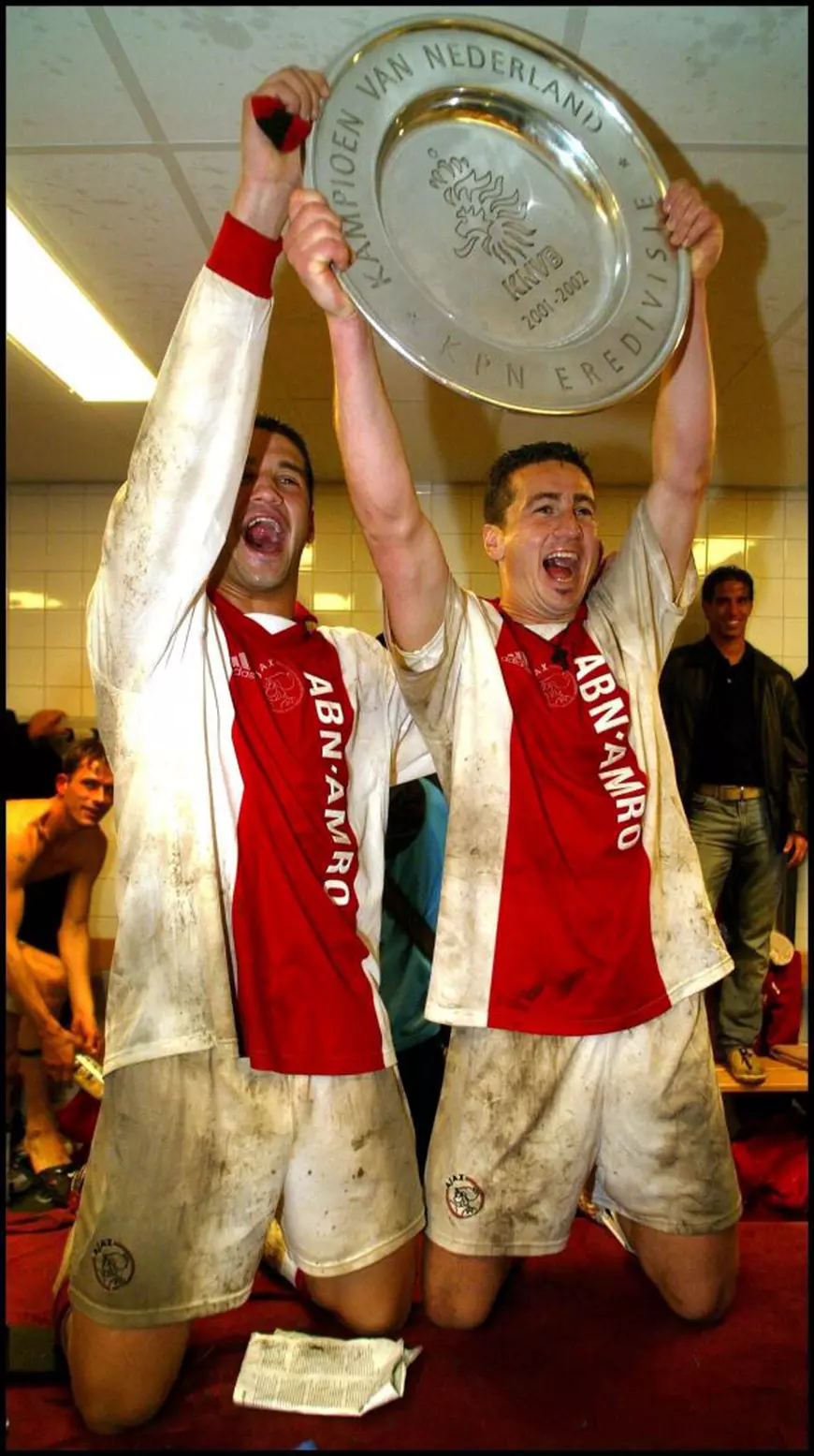 NIJ03 - 20020505 - NIJMEGEN, NETHERLANDS : Ajax-players Nikos Machlas (R) and Cristian Chivu celebrate with the trophy after their team won the Dutch first division championship for the 28th time in their history when they beat NEC Nijmegen 2-0 in Nijmegen, Sunday 05 May 2002. EPA PHOTO ANP/OLAF KRAAK/CSS/mr