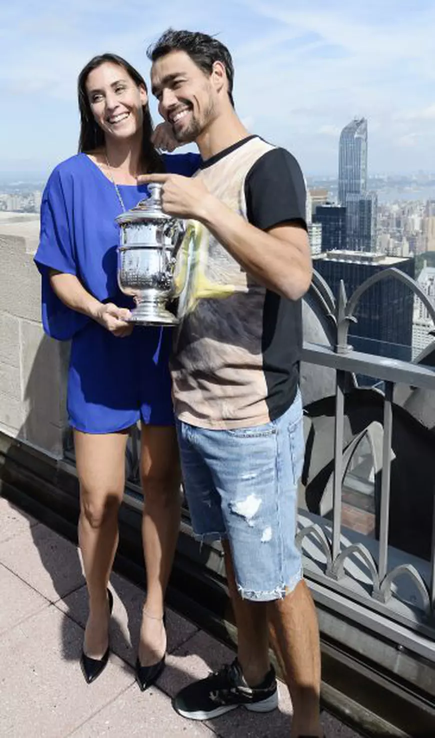 epa04928875 Flavia Pennetta of Italy (L) and her fiancee Fabio Fognini of Italy (R) pose with the Championship Trophy atop Rockefeller Plaza after defeating Roberta Vinci of Italy in the women's final on the thirteenth day of the 2015 US Open Tennis Championship at the USTA National Tennis Center in Flushing Meadows, New York, USA, 13 September 2015. The US Open runs through 13 September, which is a return to a 14-day schedule. EPA/DANIEL MURPHY