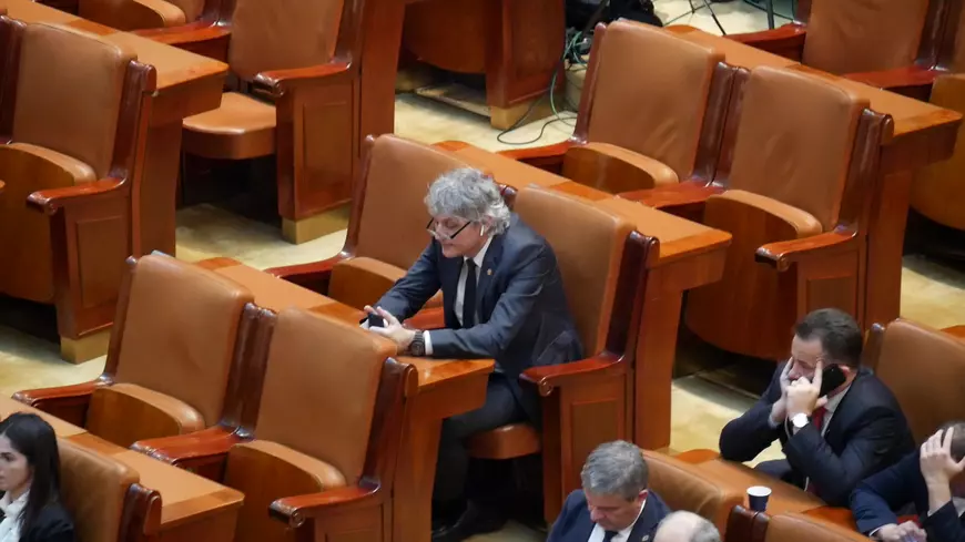 Parlamentarul social-democrat Liviu Brăiloiu se uită pe telefon în timpul Şedinţei solemne de Centenar